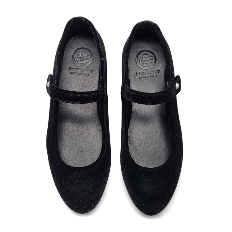 Pair of black shoes with a visible brand logo on a white background
