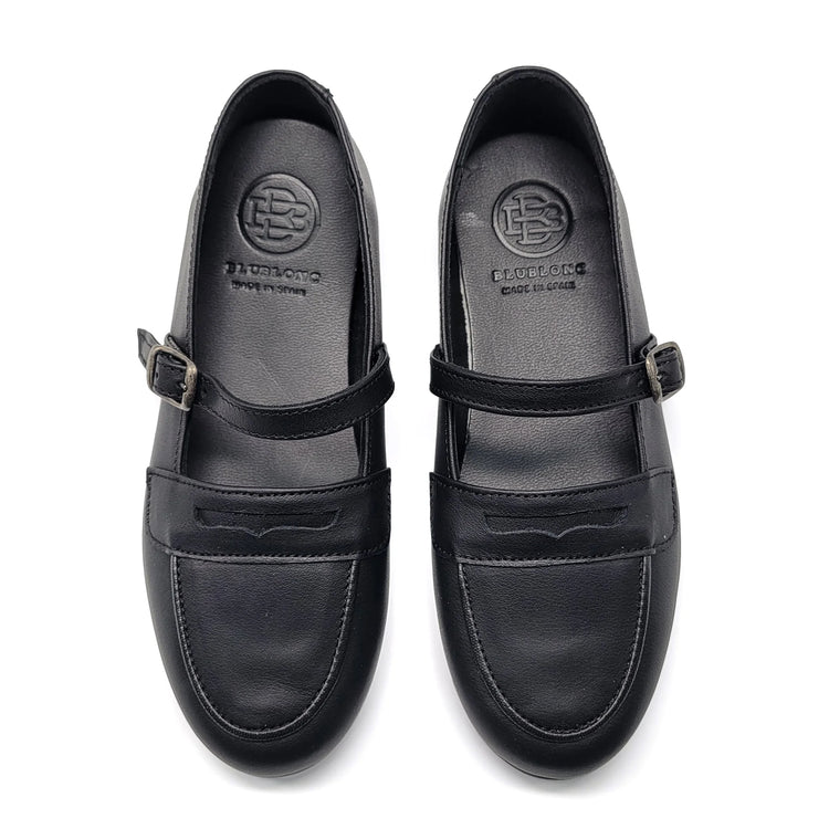 Black leather shoes with buckle details on a white background