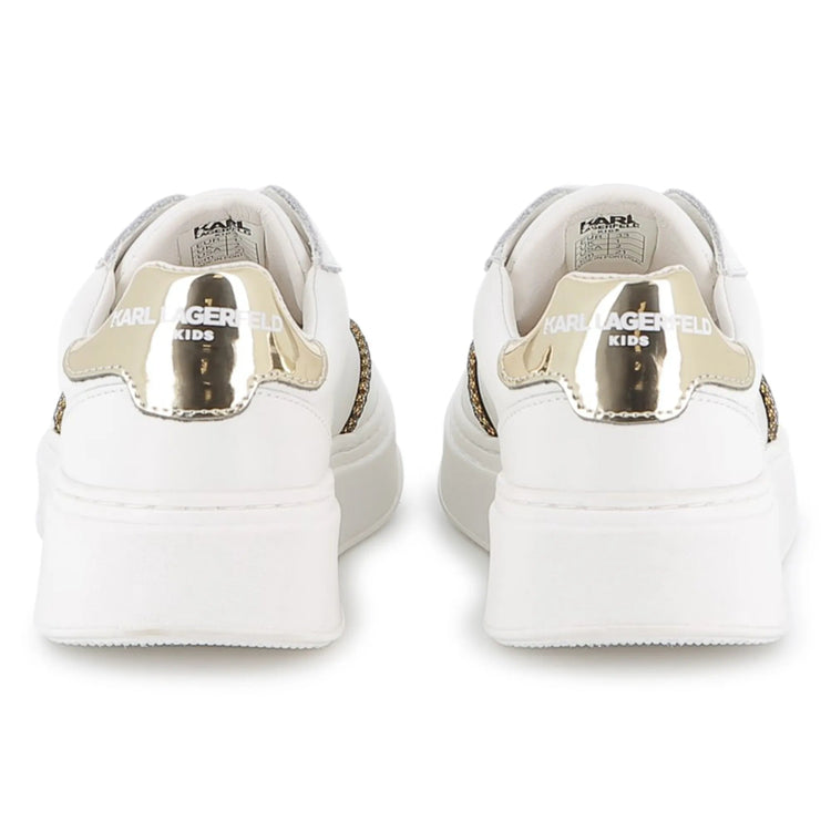 White sneakers with gold accents on a white background