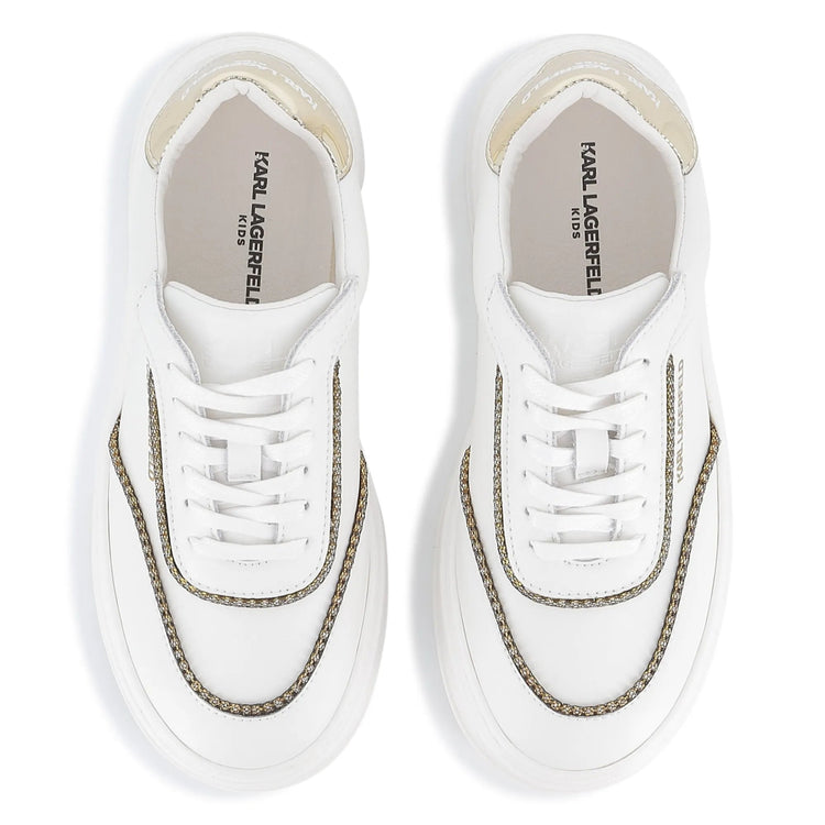 White sneakers with gold accents on a white background