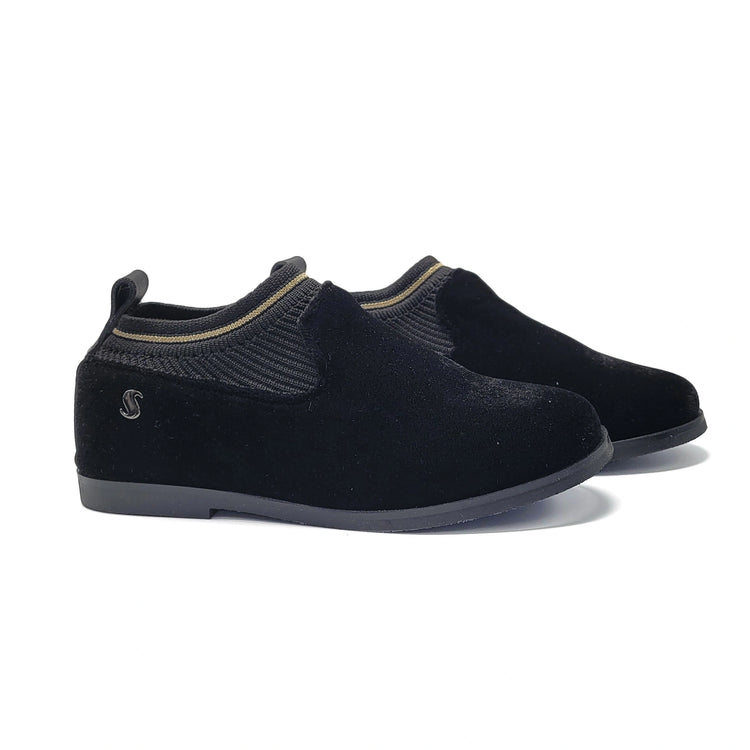 Pair of black slip-on shoes on a white background