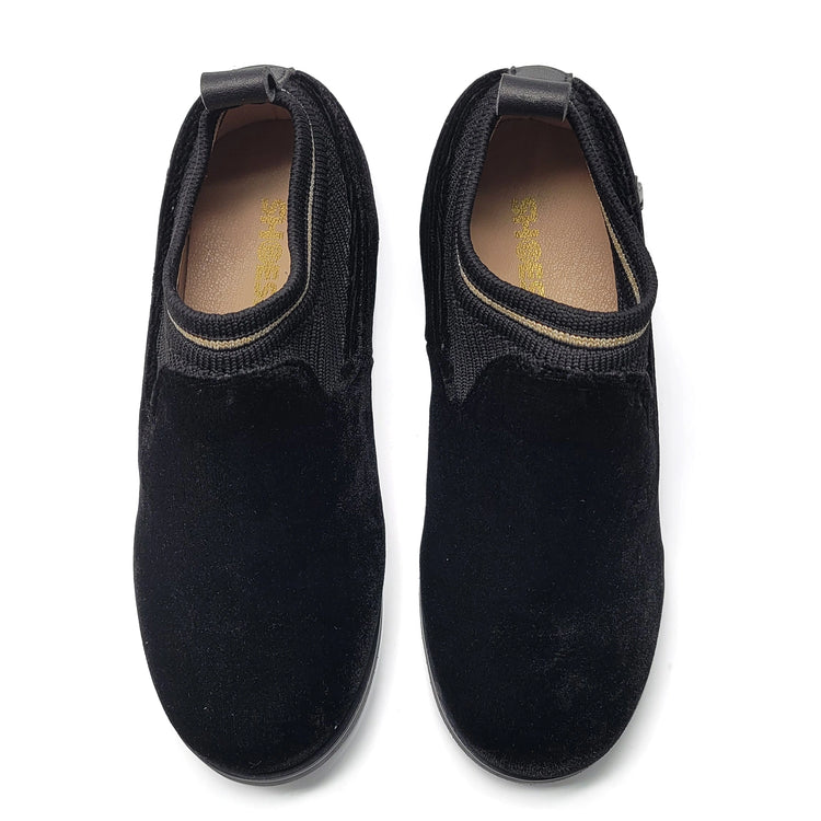 Pair of black slip-on shoes on a white background