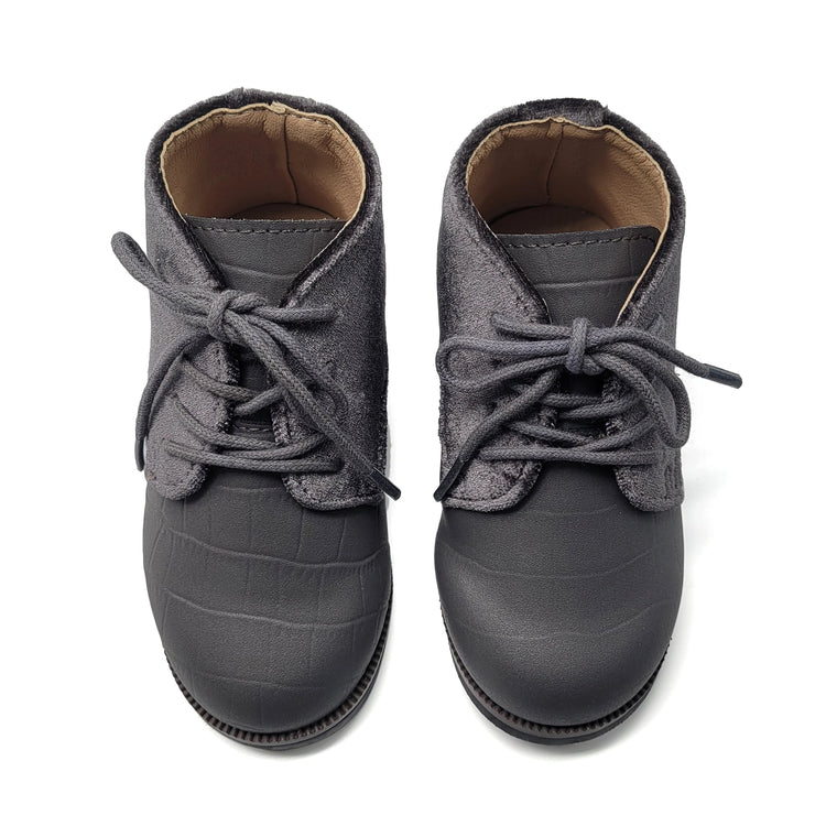 Pair of gray children's boots with laces on a white background