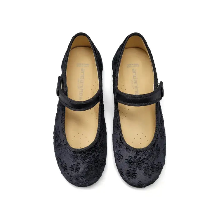 Black floral-patterned shoes with a strap on a white background