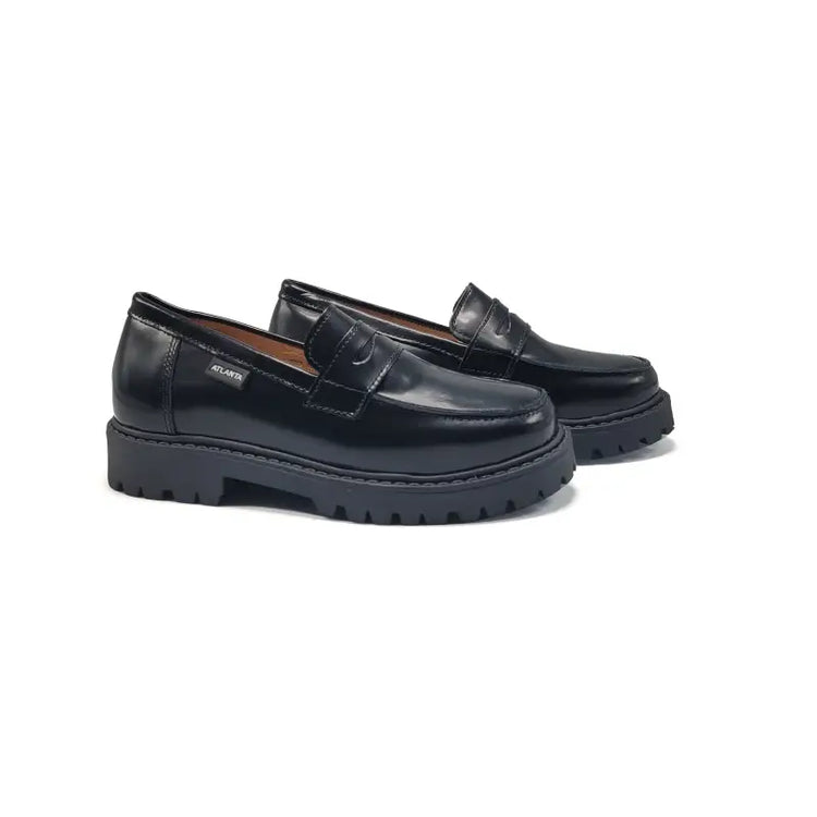 Black chunky loafers on a white background rubber sole school shoe