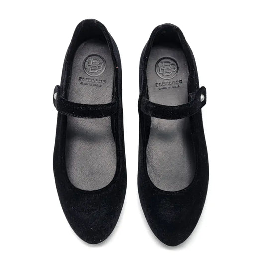 Pair of black shoes with a visible brand logo on a white background
