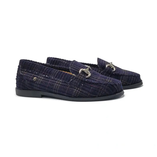 Pair of navy plaid loafers with metallic buckles on a white background
