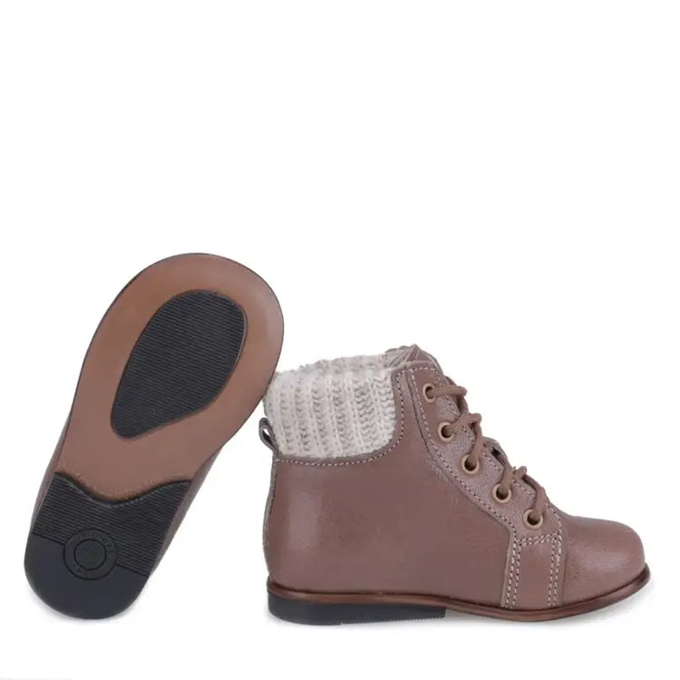 Brown children's boots with a textured sole on a white background