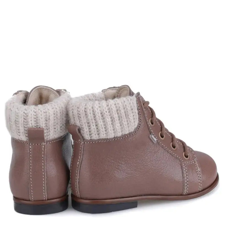 Pair of brown leather boots with knit cuffs on a white background