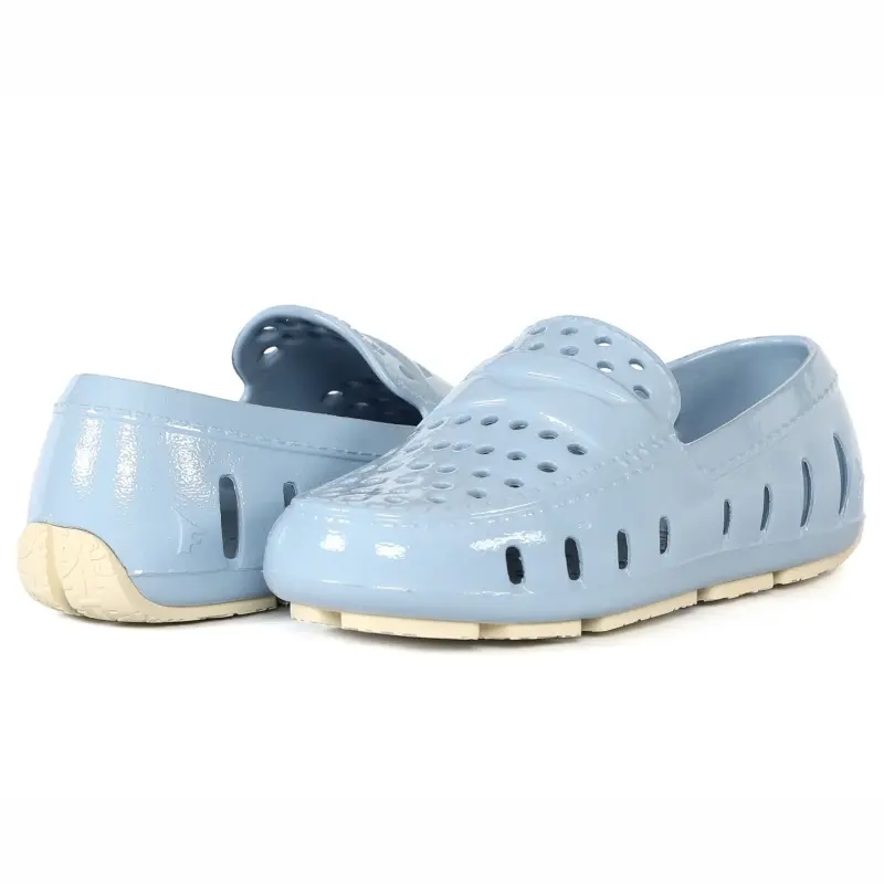 Pair of light blue clogs on a white background