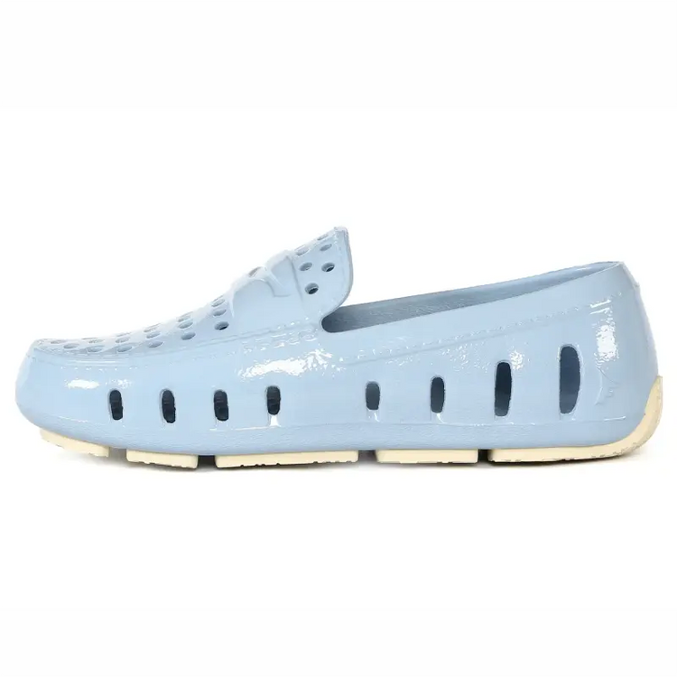 Light blue shoe with a white sole on a white background