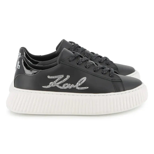 Black sneakers with 'Karl' branding on a white background