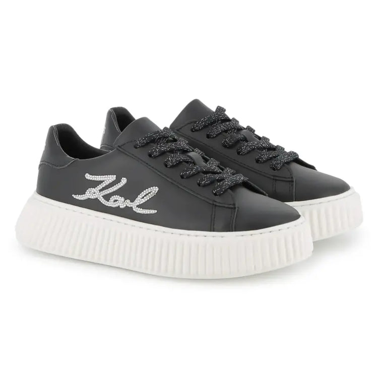 Black sneakers with white sole on a white background