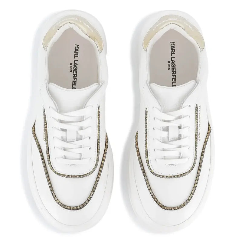 White sneakers with gold accents on a white background