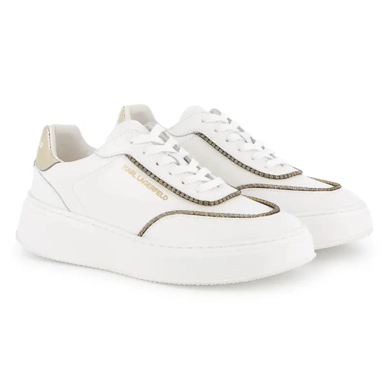 White sneakers with gold accents on a white background