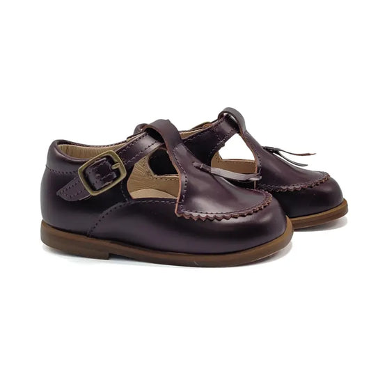 Pair of brown children's shoes with a buckle on a white background