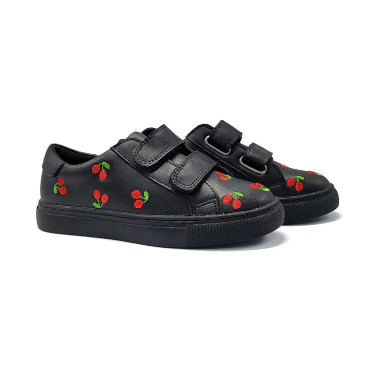 Black sneakers with cherry designs on a white background
