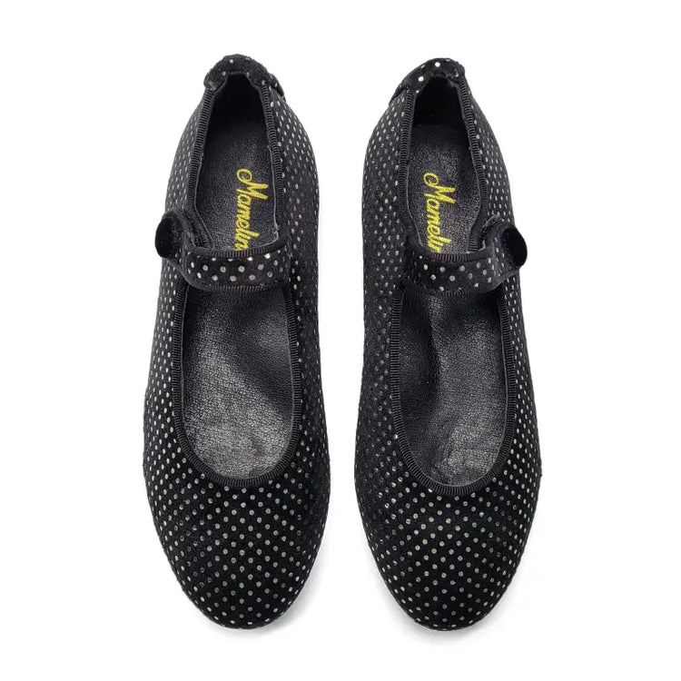 Pair of black polka dot shoes with a brand logo on a white background