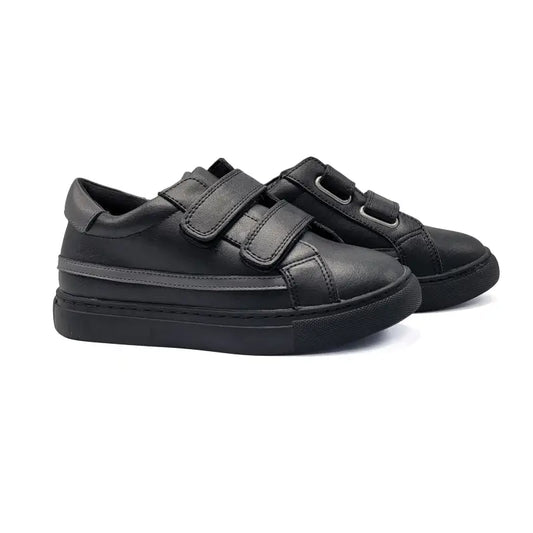 Black sneakers with velcro straps on a white background