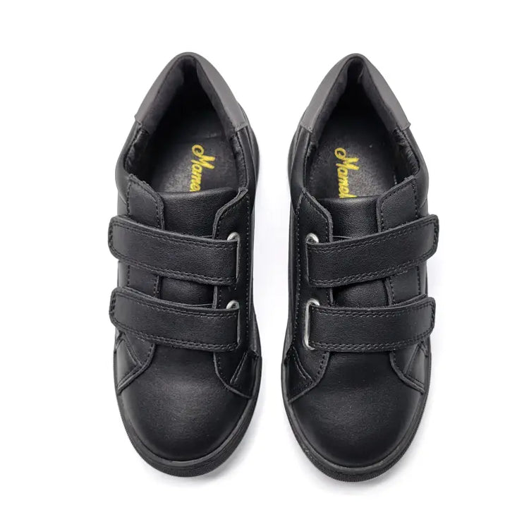 Pair of black shoes with velcro straps on a white background