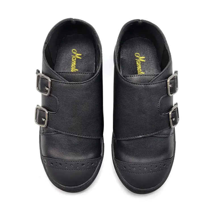 Pair of black shoes with buckles on a white background