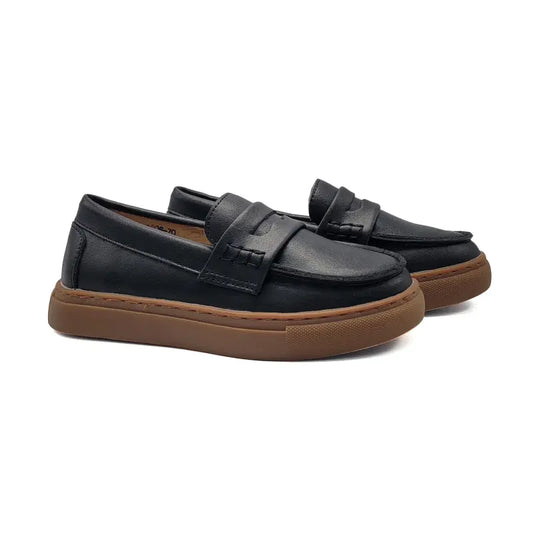 Black loafers with brown soles on a white background