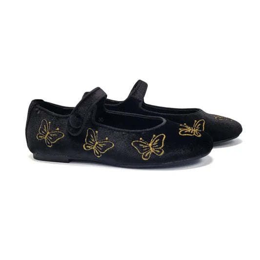 Black shoes with gold butterfly designs on a white background