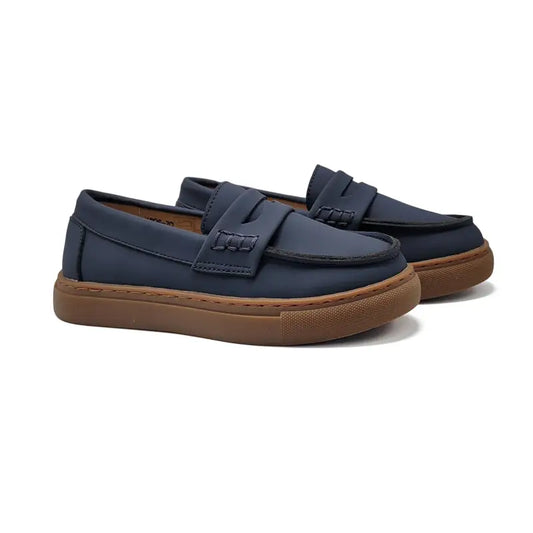 Pair of navy loafers with brown soles on a white background