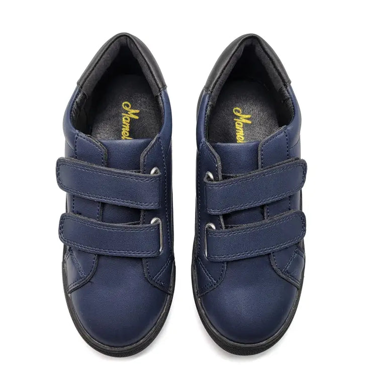 Pair of blue children's shoes with velcro straps on a white background