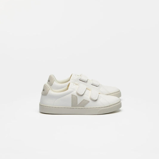 White sneakers with velcro straps on a light gray background