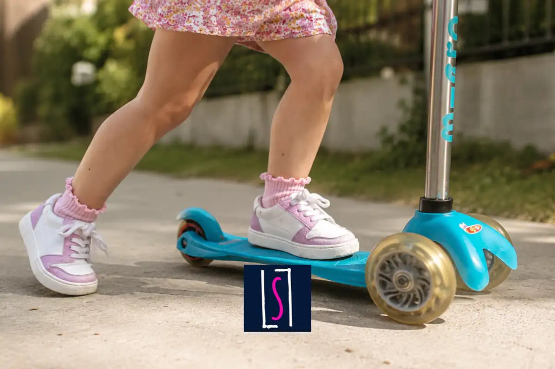 Child riding a scooter wearing durable kids sneakers with reinforced toe protection.