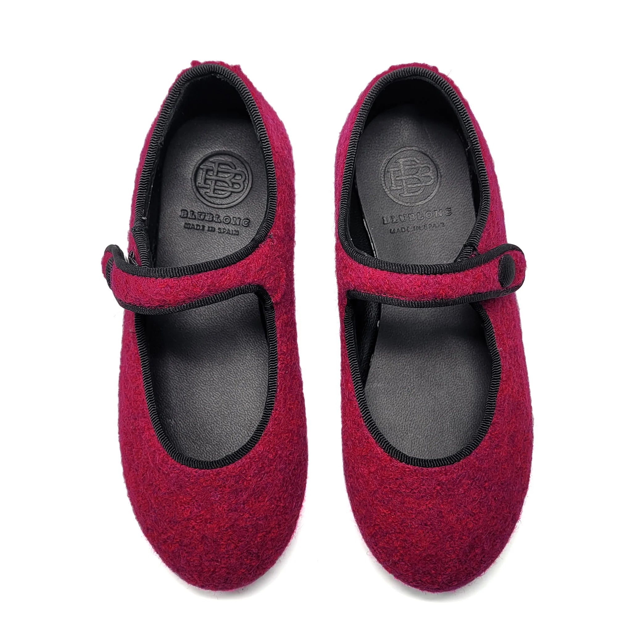 Pair of fuchsia mary jane with black soles on a white background