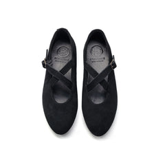 Pair of black mary jane with a criss-cross strap on a white background