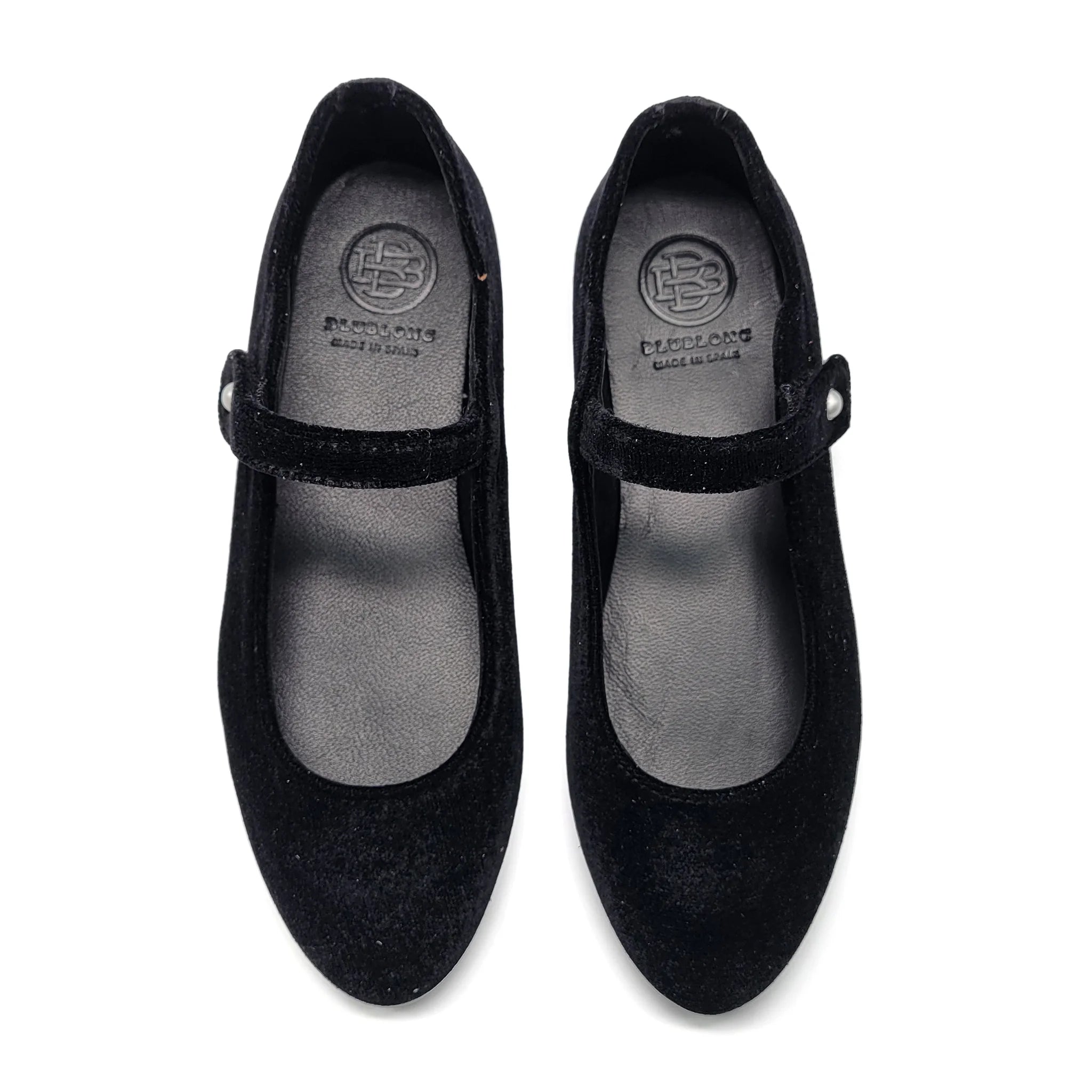 Pair of black shoes with a visible brand logo on a white background