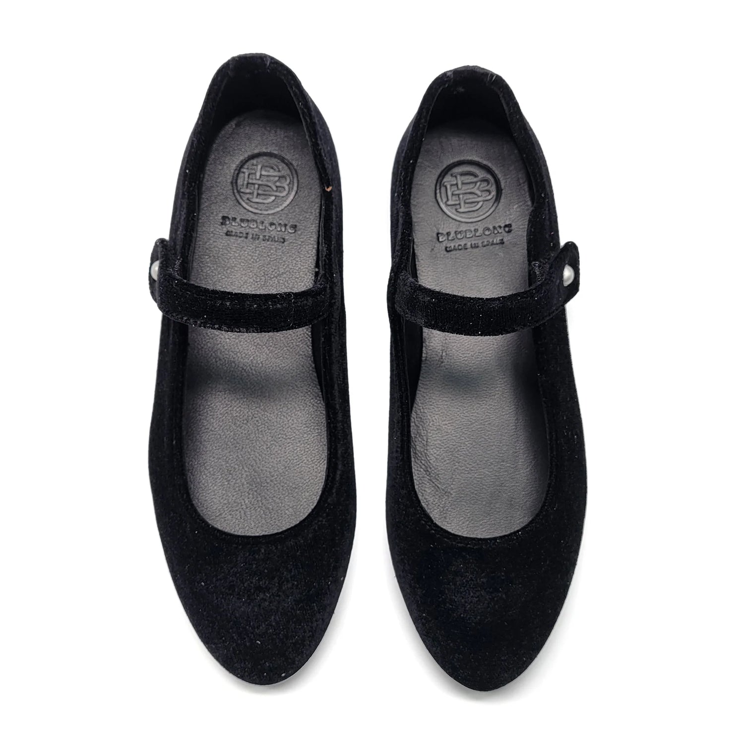 Pair of black shoes with a visible brand logo on a white background