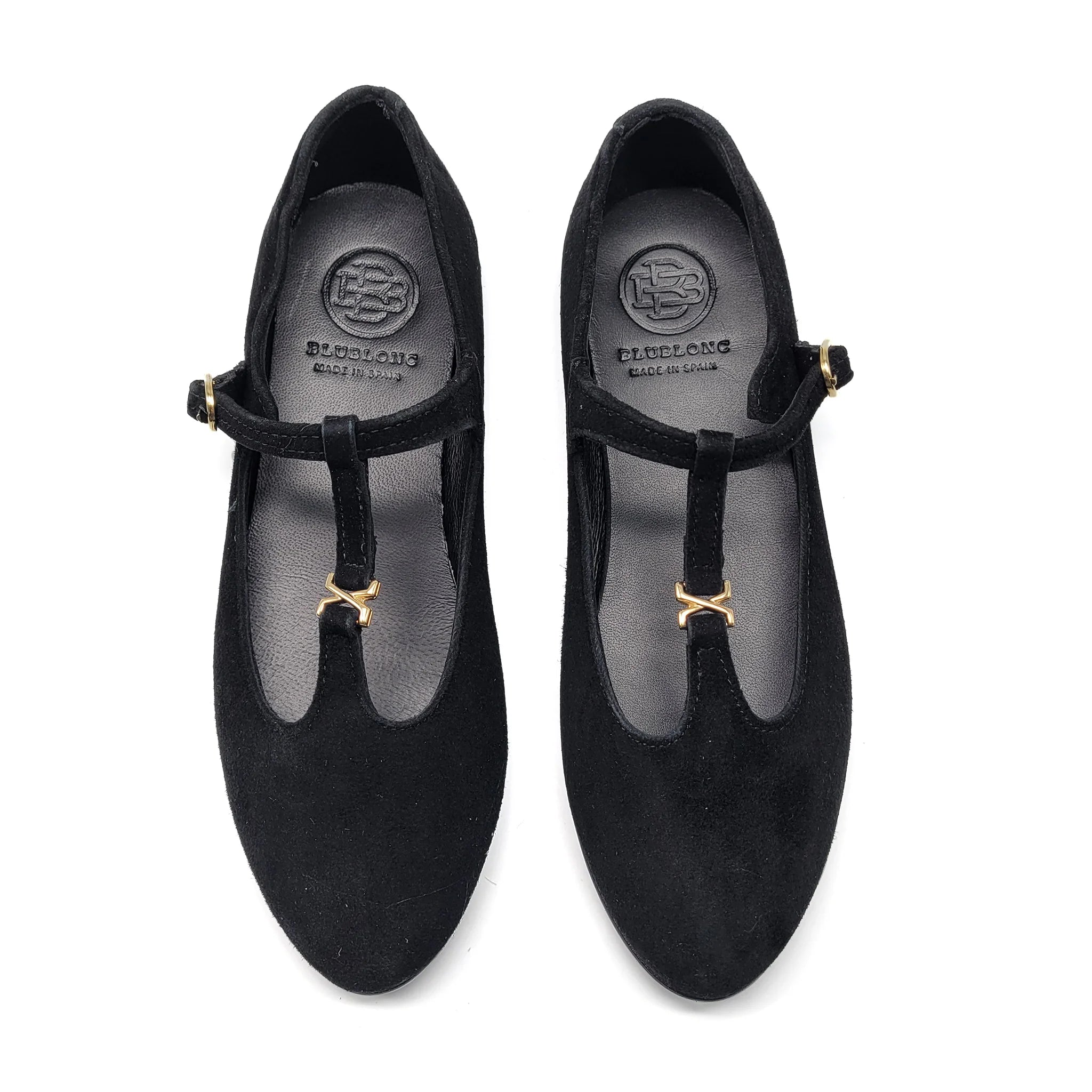 Pair of black shoes with gold accents on a white background