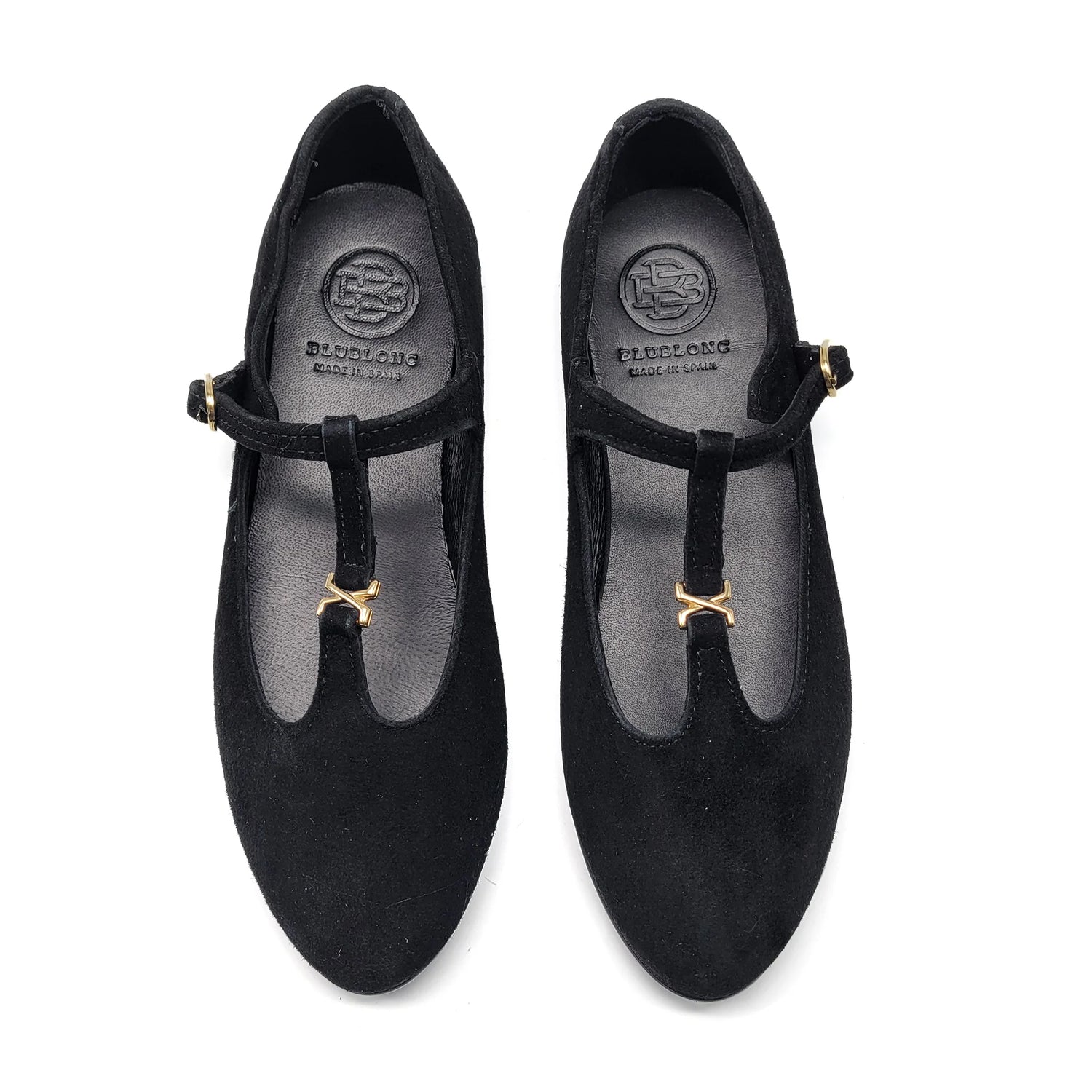 Pair of black shoes with gold accents on a white background
