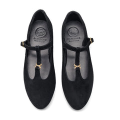 Pair of black shoes with gold accents on a white background