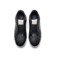 Black slip-on shoes with 'Cole' branding on a white background