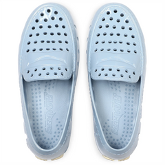 Pair of light blue slip-on shoes with a brand logo on a white background