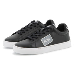 Black sneakers with a visible brand logo on a white background