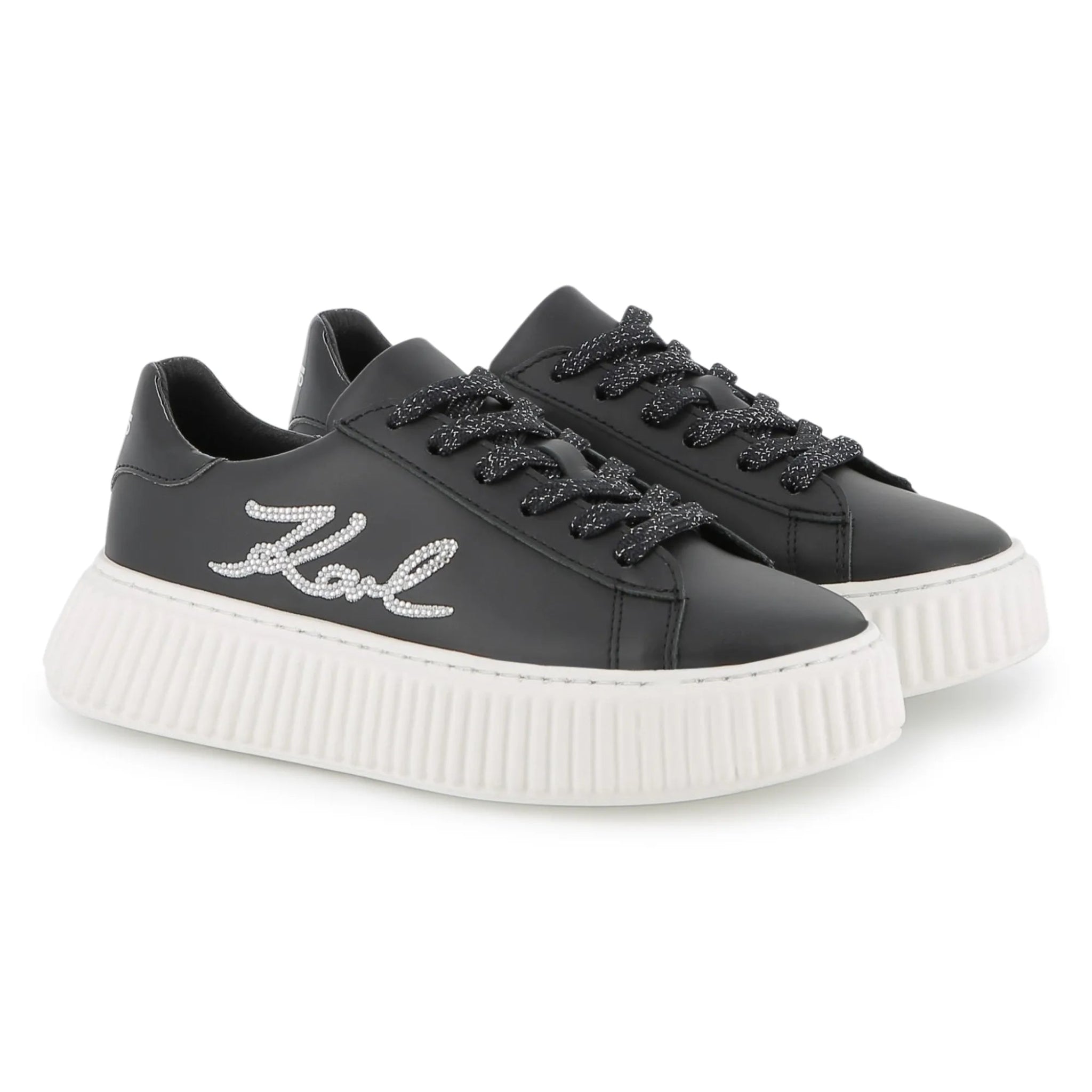 Black sneakers with white sole on a white background