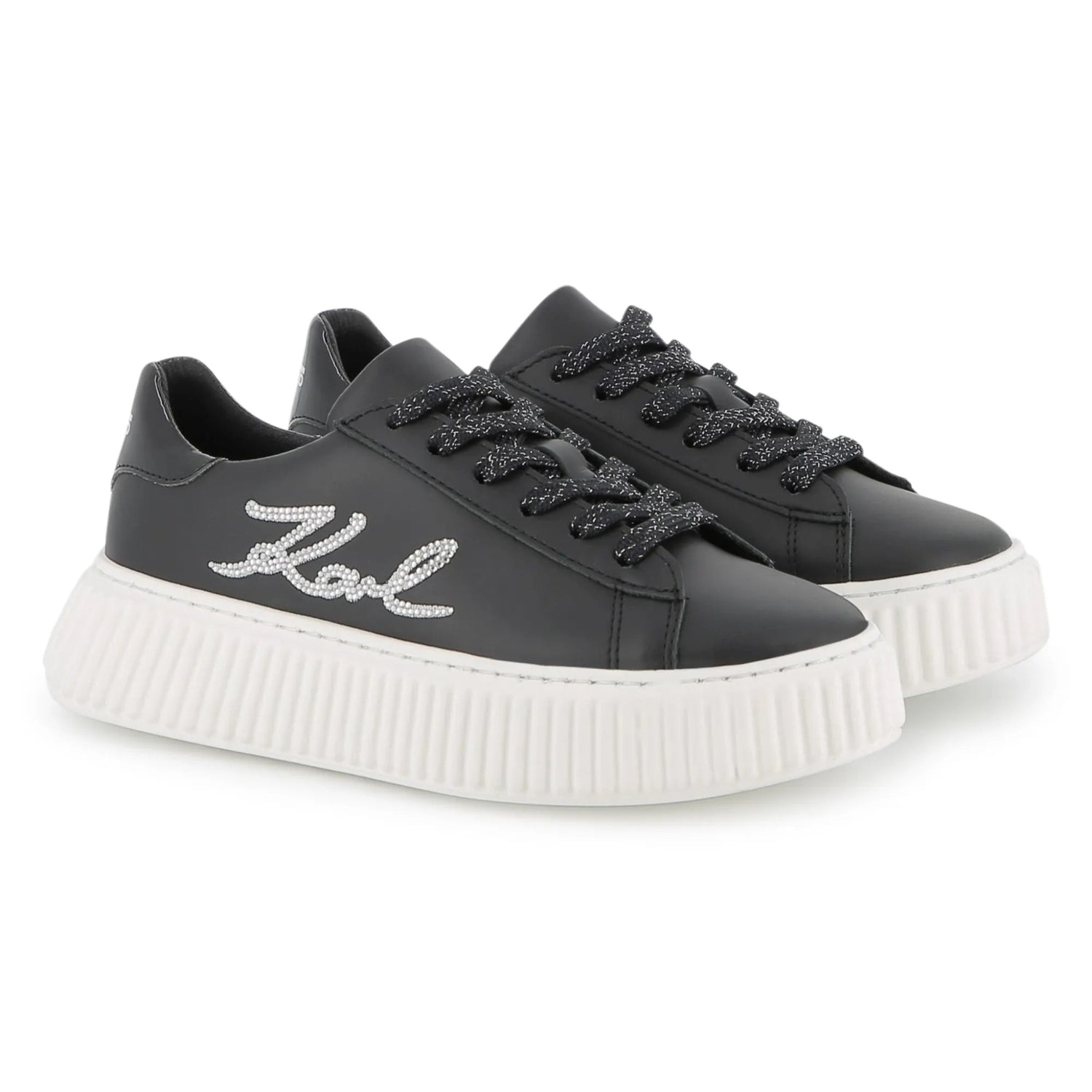 Black sneakers with white sole on a white background