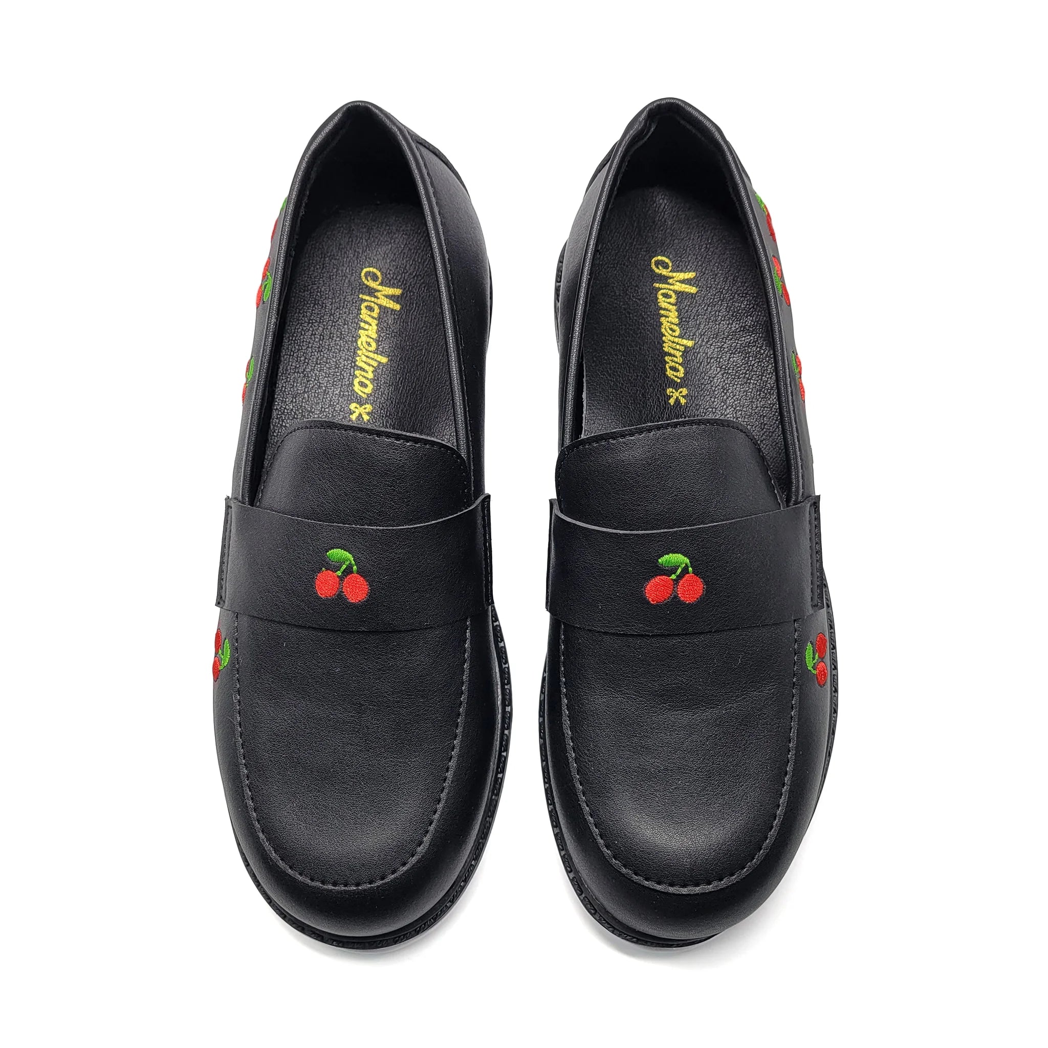 Black loafers with cherry designs on a white background