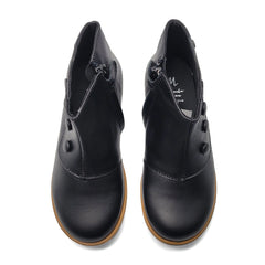 Pair of black leather shoes with brown soles on a white background
