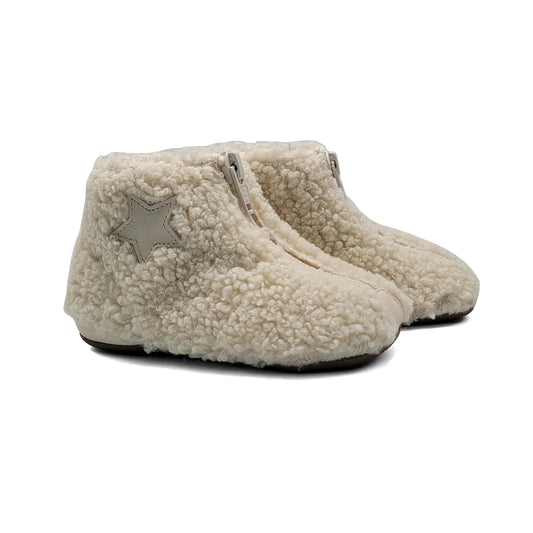 Pair of beige fleece-lined slippers on a white background
