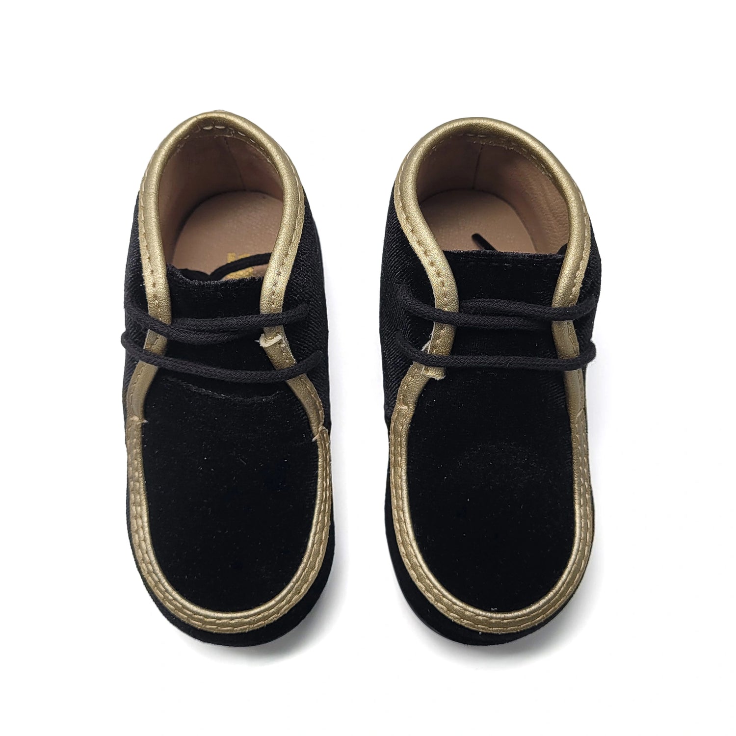Pair of black shoes with gold trim on a white background