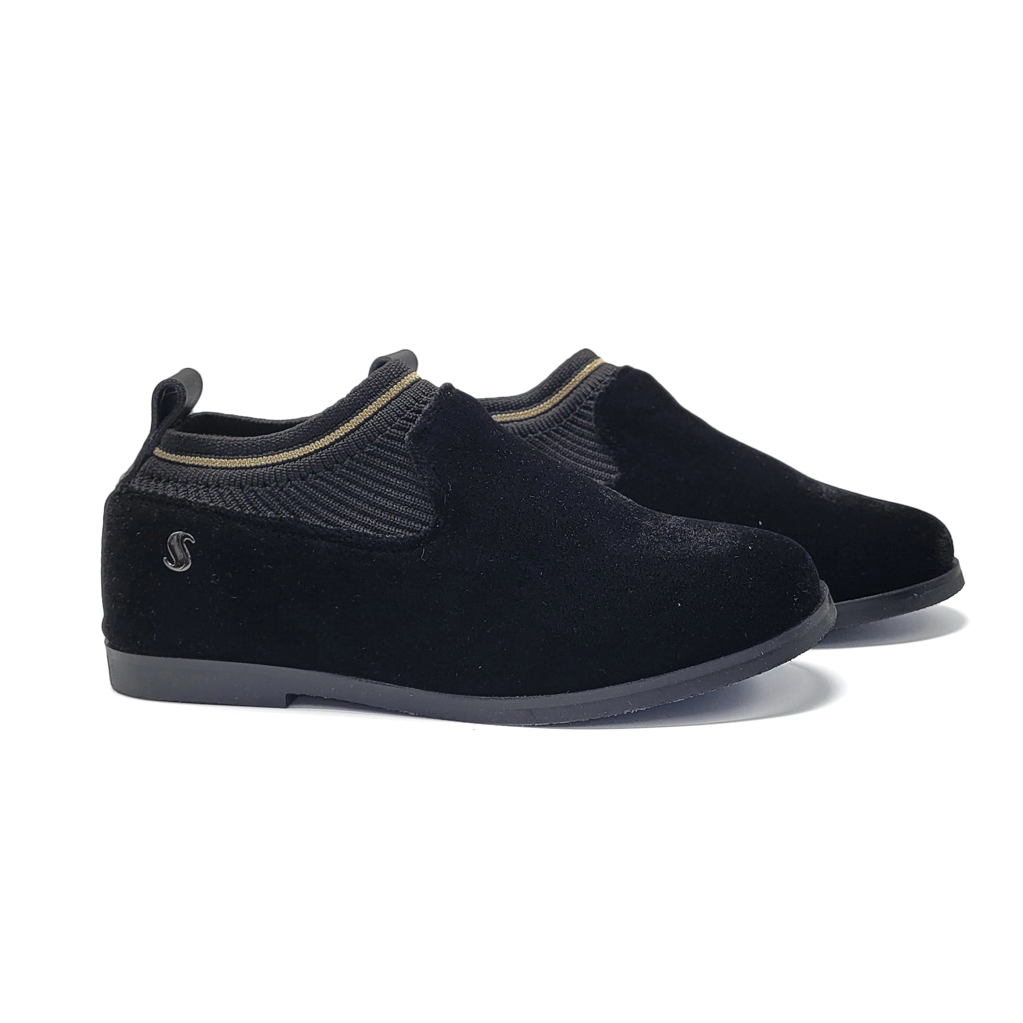 Pair of black slip-on shoes on a white background