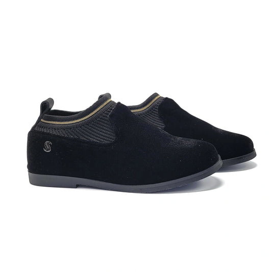 Pair of black slip-on shoes on a white background