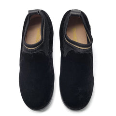 Pair of black slip-on shoes on a white background